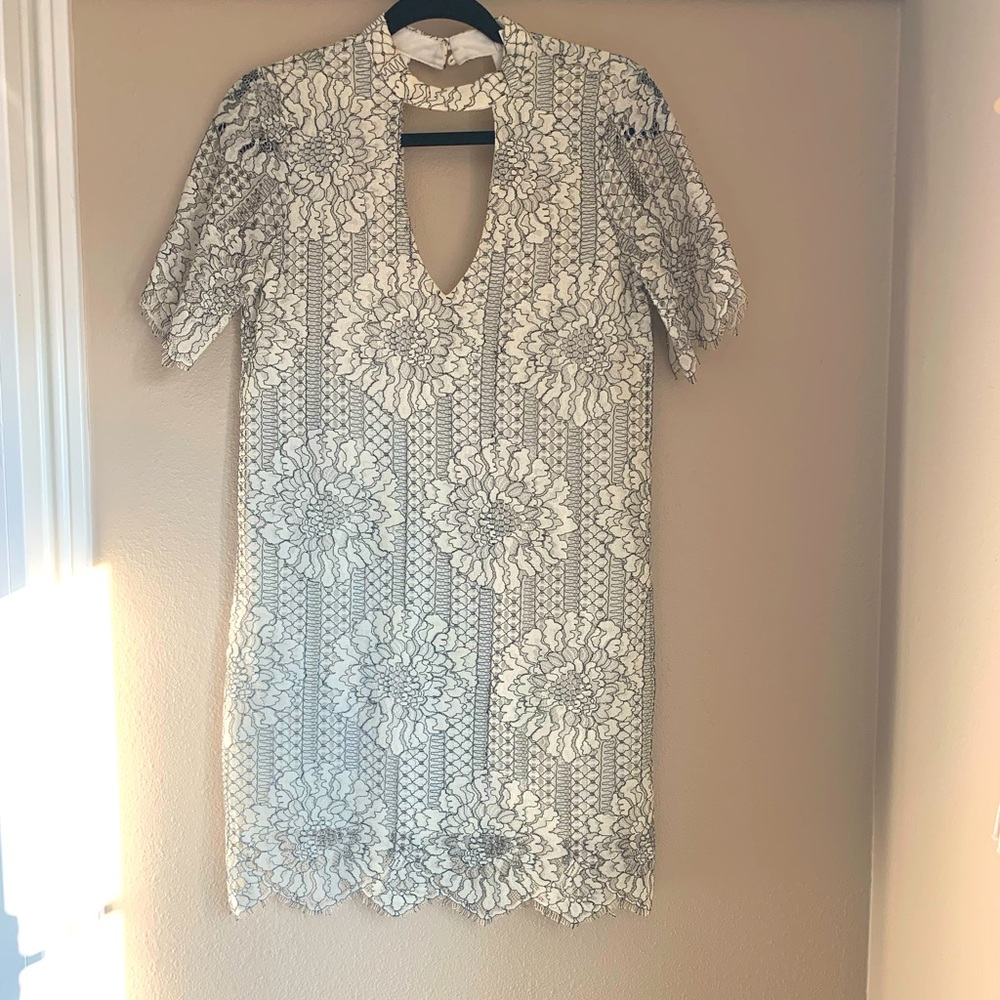 Socliate black and white lace floral mini dress with high neck cut out.